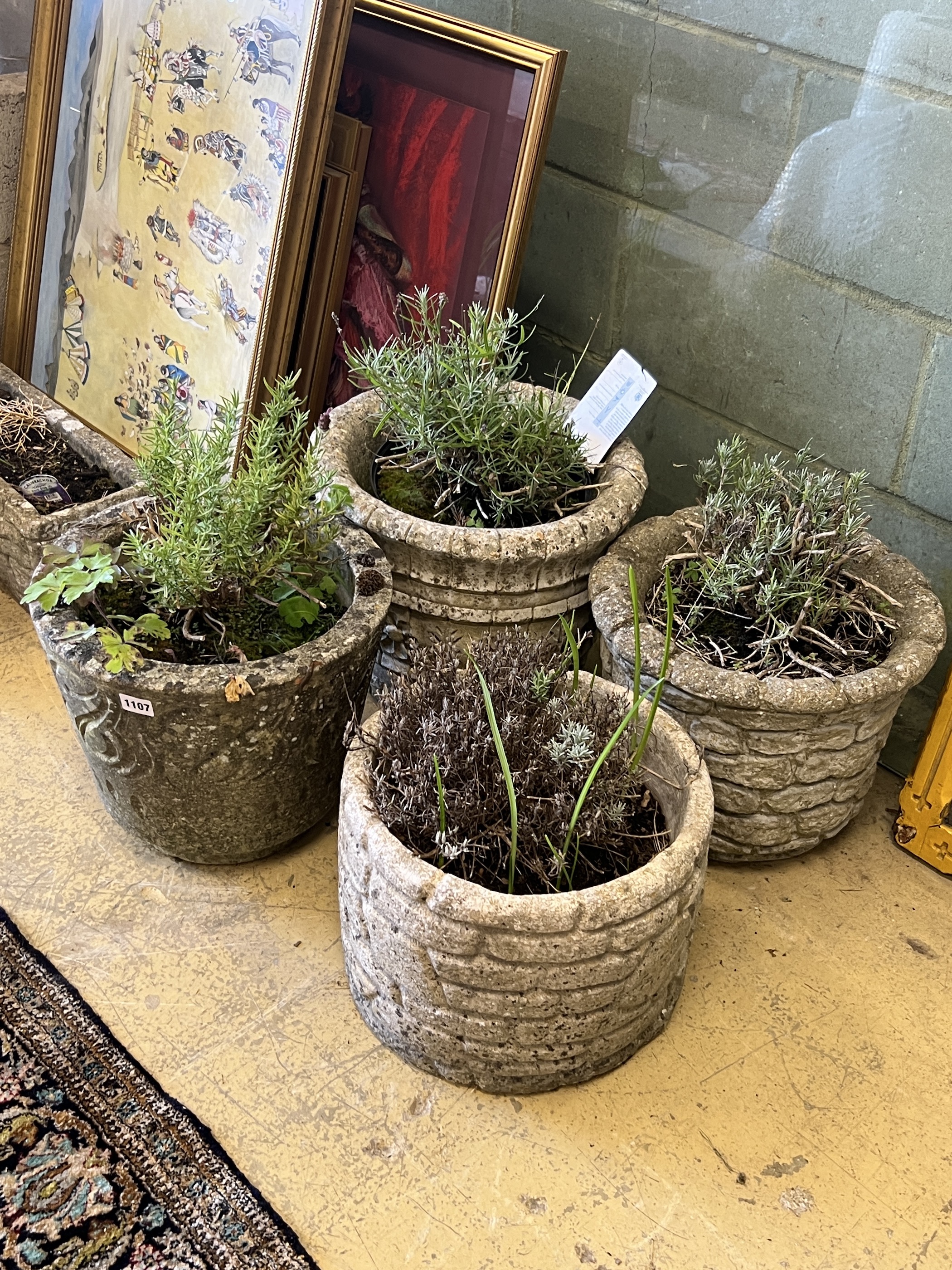 Four circular reconstituted stone garden planters, largest diameter 38cm, height 30cm